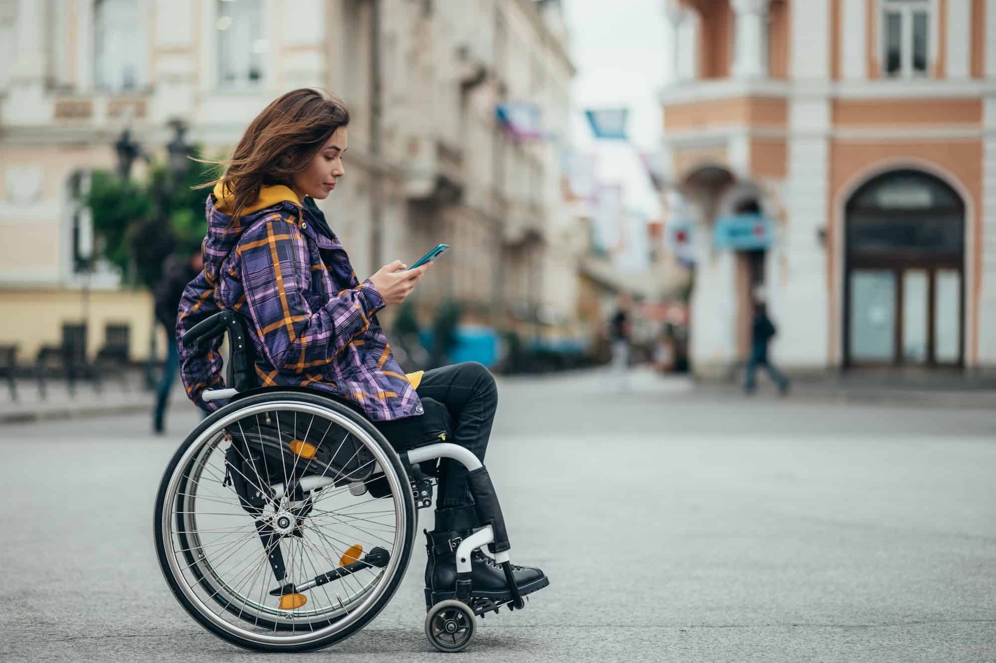 woman-with-disability-using-a-smartphone-while-out-in-the-city.jpg